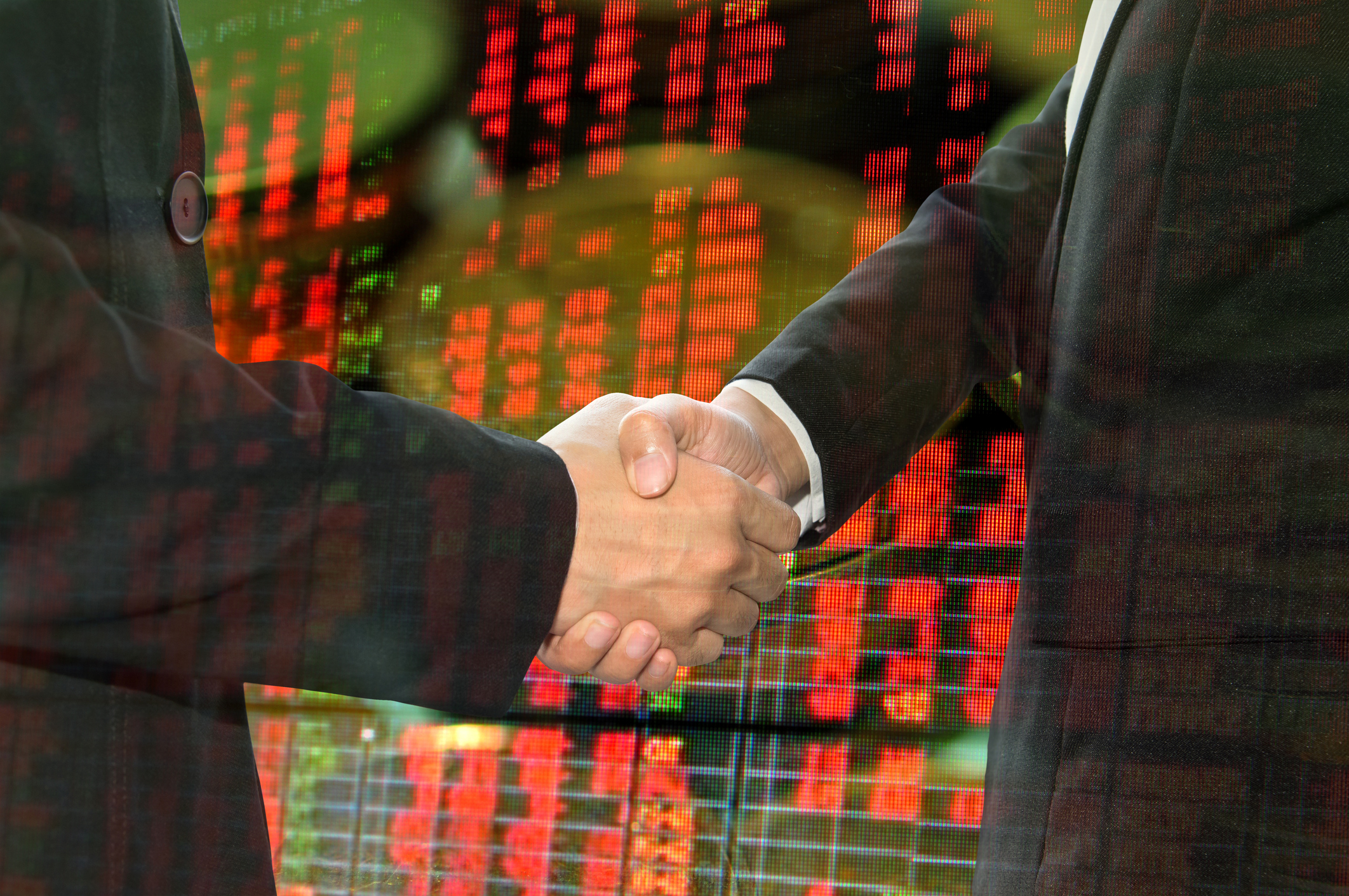 Business shaking hand on finacial graph background.